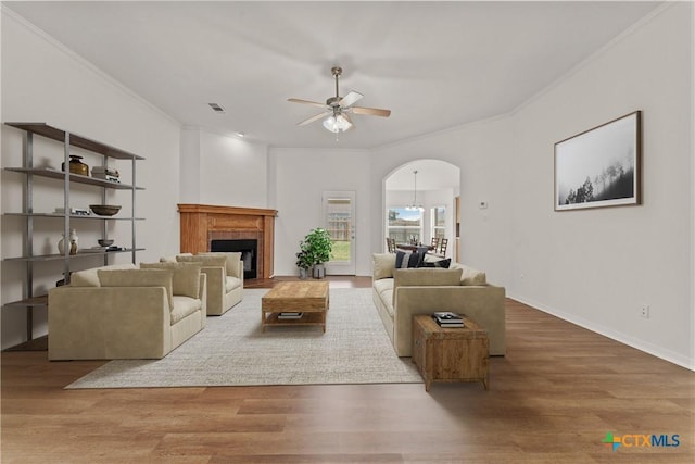 3511 Llano Estacado Ct, Killeen, TX 76549 - living area featuring a ceiling fan, ornamental molding, arched walkways, wood finished floors, and a fireplace