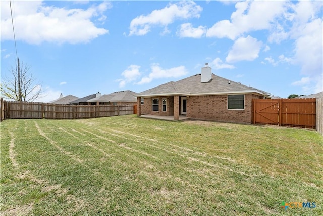 3511 Llano Estacado Ct, Killeen, TX 76549 - back of property with a patio area, brick siding, and a chimney