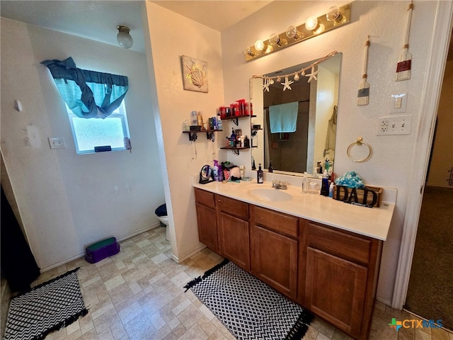 bathroom featuring vanity and toilet