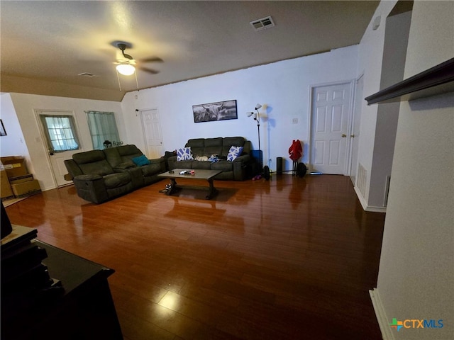 living room with ceiling fan and dark hardwood / wood-style flooring