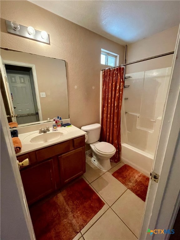 full bathroom featuring tile patterned flooring, vanity, toilet, and shower / tub combo with curtain