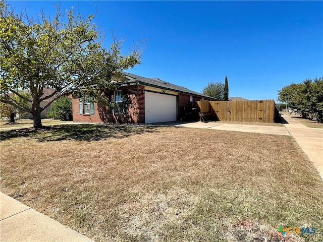 view of front of home with a garage and a front lawn