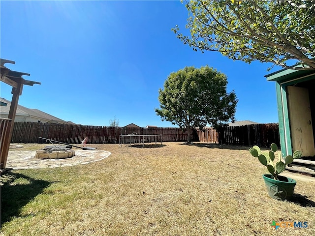 view of yard featuring a fire pit and a patio area