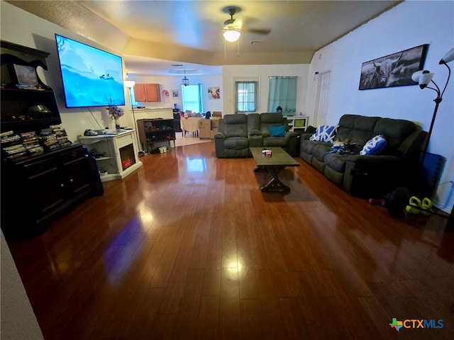 living room with hardwood / wood-style flooring and ceiling fan