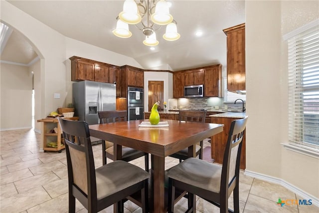 2034 Falling Leaf Ln, Harker Heights, TX 76548 - dining area featuring arched walkways, a wealth of natural light, baseboards, and a chandelier