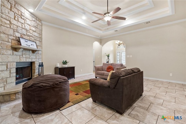 2034 Falling Leaf Ln, Harker Heights, TX 76548 - living room with ceiling fan, crown molding, arched walkways, a fireplace, and a raised ceiling