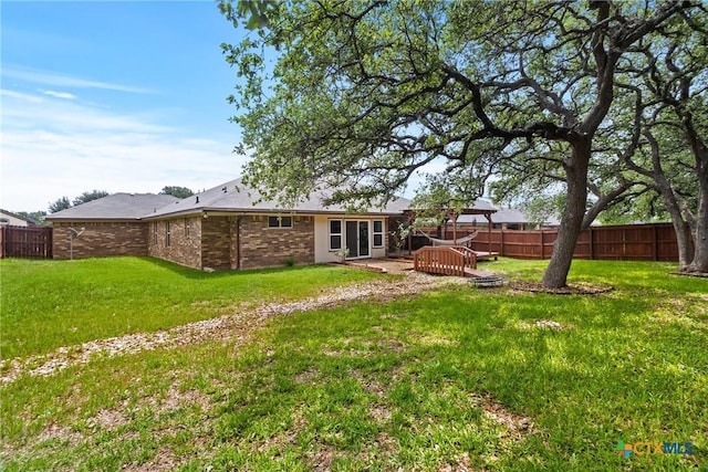 2034 Falling Leaf Ln, Harker Heights, TX 76548 - back of house with a lawn, brick siding, and a fenced backyard