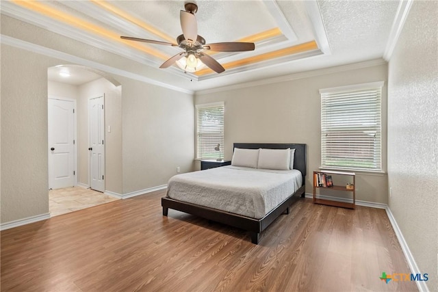 2034 Falling Leaf Ln, Harker Heights, TX 76548 - bedroom with arched walkways, ornamental molding, a textured wall, and wood finished floors