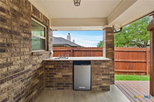 2034 Falling Leaf Ln, Harker Heights, TX 76548 - view of patio with a fenced backyard, outdoor wet bar, a sink, and a wooden deck