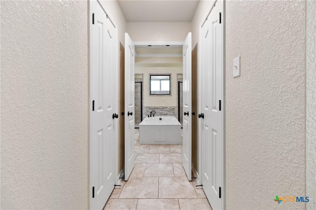 2034 Falling Leaf Ln, Harker Heights, TX 76548 - hallway with a textured wall and light tile patterned flooring