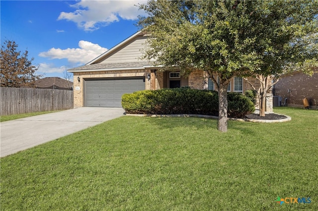 view of front of home with a front yard and a garage