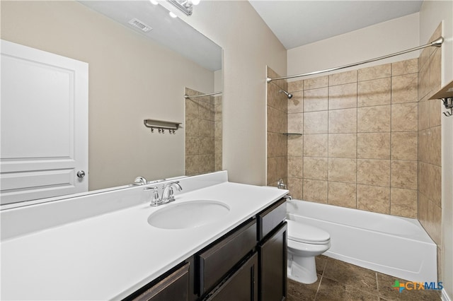 full bathroom featuring toilet, vanity, and tiled shower / bath combo