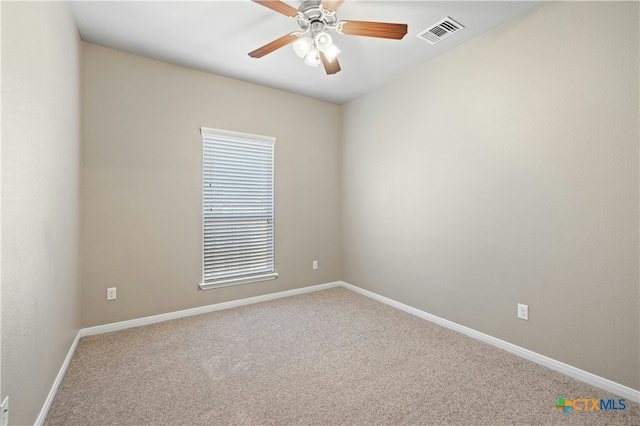 carpeted empty room featuring ceiling fan