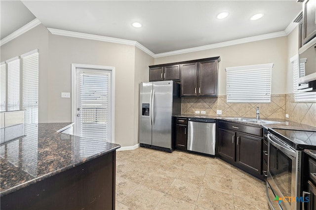 kitchen with tasteful backsplash, appliances with stainless steel finishes, ornamental molding, dark brown cabinets, and sink