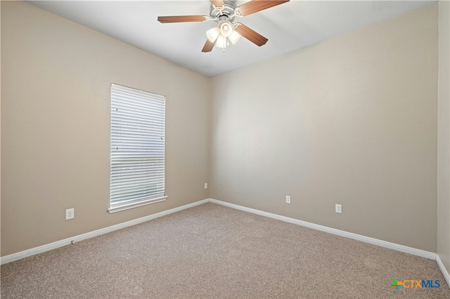 carpeted spare room featuring ceiling fan