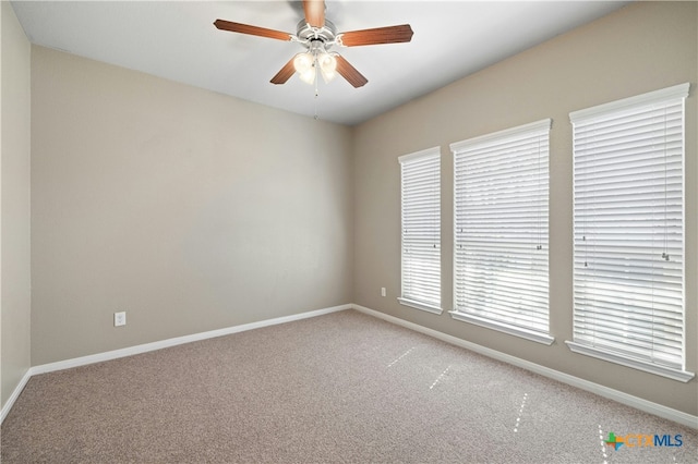 unfurnished room featuring ceiling fan and carpet floors