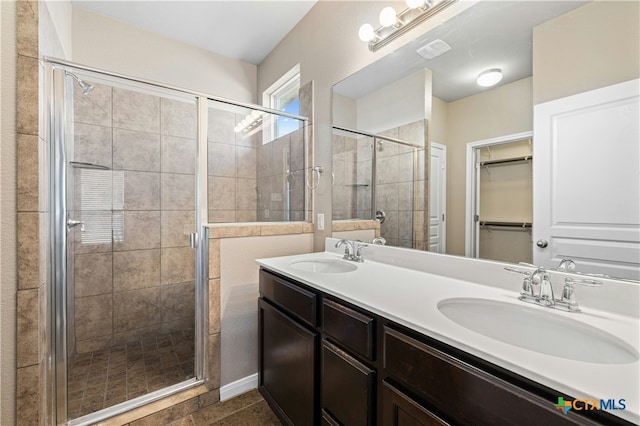 bathroom featuring an enclosed shower and vanity