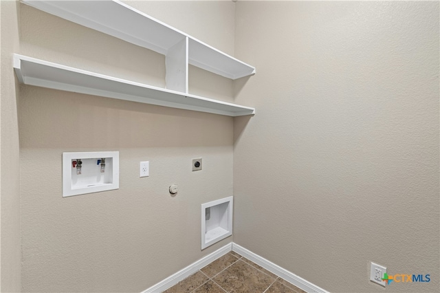 clothes washing area featuring electric dryer hookup, dark tile patterned flooring, hookup for a gas dryer, and washer hookup