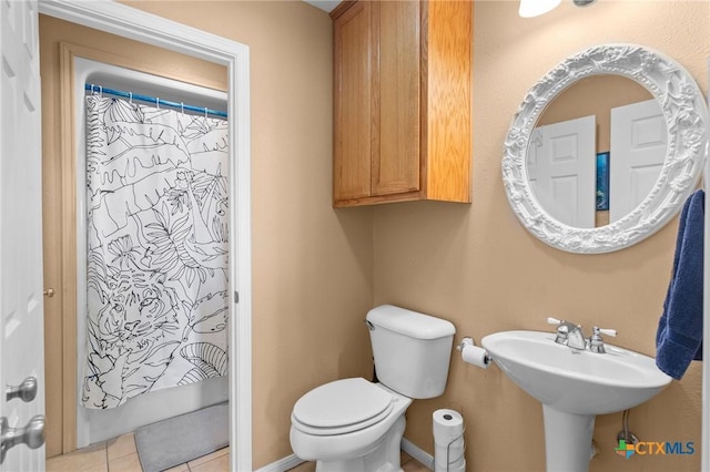 bathroom with tile patterned floors and toilet