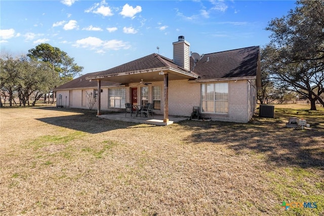 rear view of property featuring ceiling fan, a lawn, a patio area, and central air condition unit