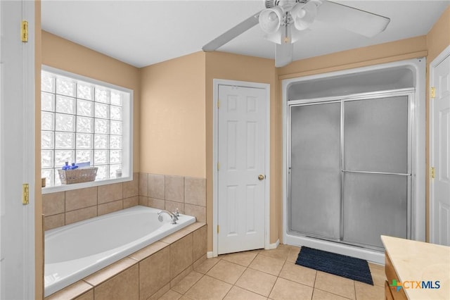 bathroom with ceiling fan, tile patterned floors, vanity, and plus walk in shower