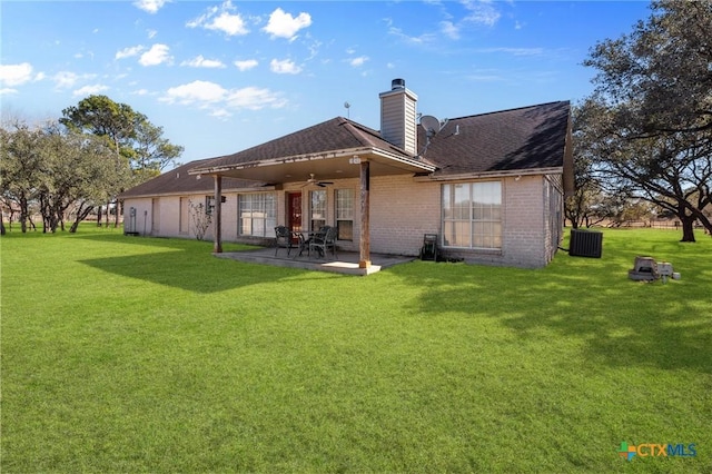 back of property featuring a lawn, central AC unit, ceiling fan, and a patio area