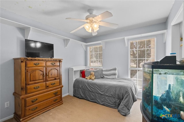 carpeted bedroom with ceiling fan and multiple windows