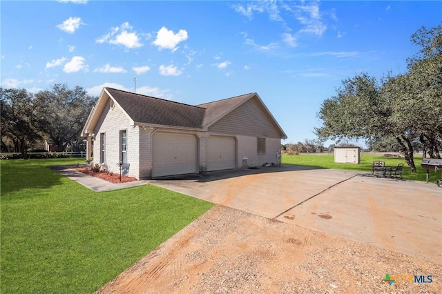 view of side of home featuring a storage shed, a yard, and a garage