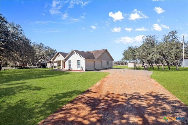 view of front of property with a garage and a front lawn