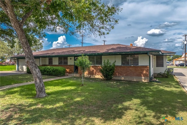 single story home with a garage, aphalt driveway, a front lawn, and brick siding