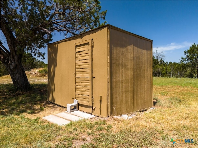 view of outdoor structure with a lawn