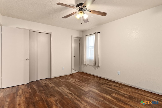 unfurnished bedroom with a textured ceiling, ceiling fan, a closet, and dark hardwood / wood-style floors