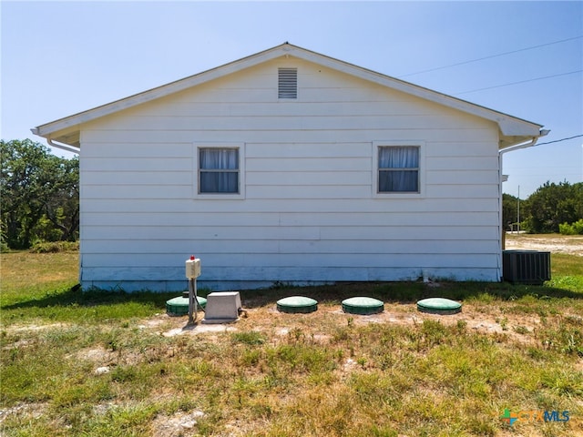 view of side of home featuring cooling unit