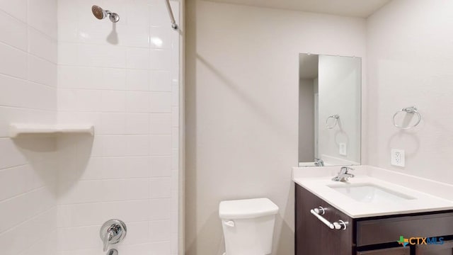 bathroom with toilet, vanity, and  shower combination