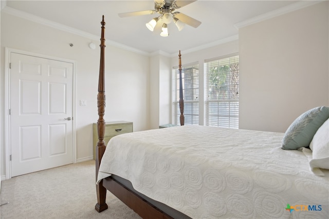 carpeted bedroom with ceiling fan and ornamental molding