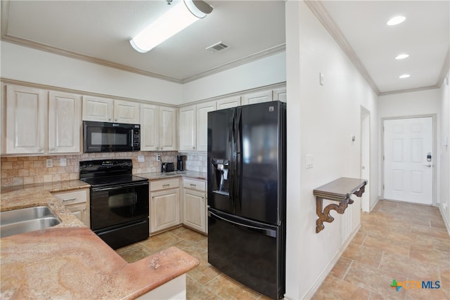 kitchen featuring sink, backsplash, cream cabinets, black appliances, and ornamental molding