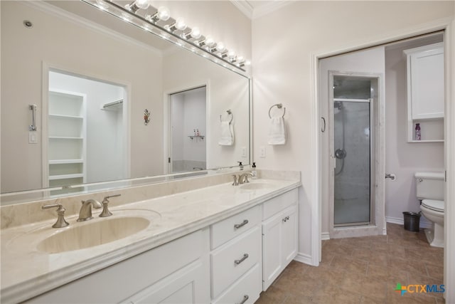 bathroom featuring vanity, toilet, ornamental molding, and walk in shower