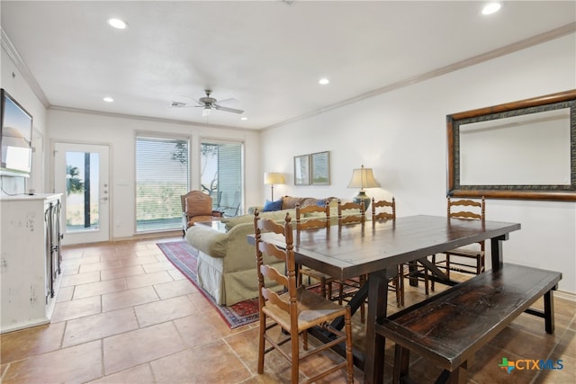 dining space featuring ceiling fan and crown molding