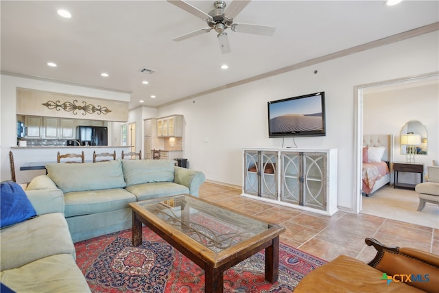 living room with ceiling fan and crown molding