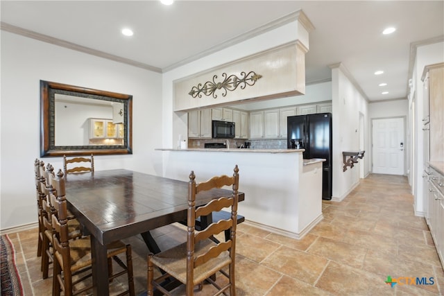 dining area featuring crown molding