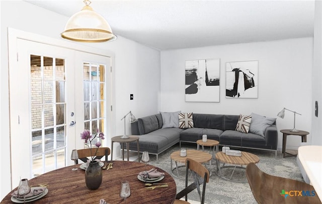 living room featuring a wealth of natural light and french doors