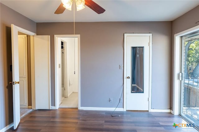 unfurnished bedroom with access to outside, dark wood finished floors, a ceiling fan, and baseboards