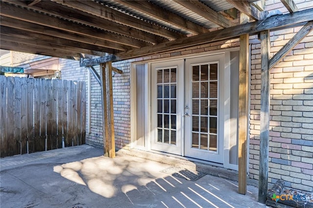 view of patio / terrace featuring fence and french doors