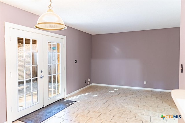 spare room with french doors and baseboards