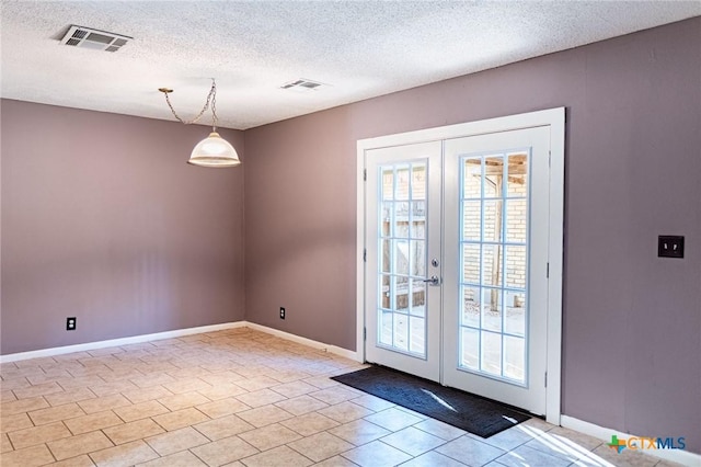 doorway to outside featuring a textured ceiling, french doors, visible vents, and baseboards