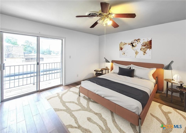 bedroom with access to exterior, ceiling fan, and wood finished floors