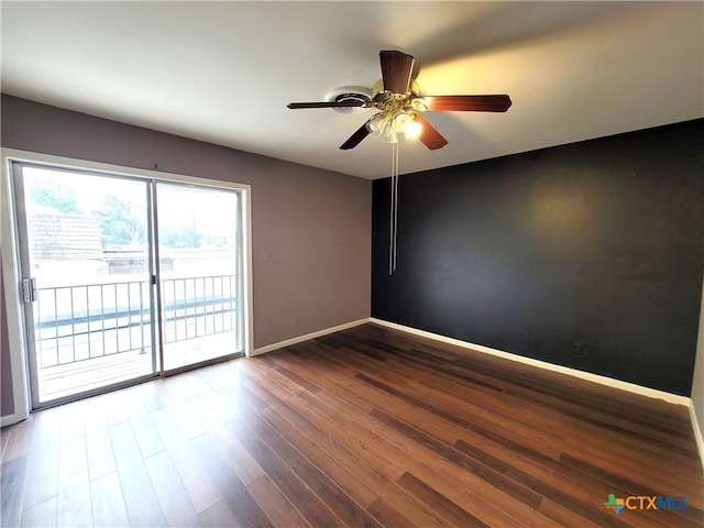 spare room with dark wood-style floors, ceiling fan, and baseboards