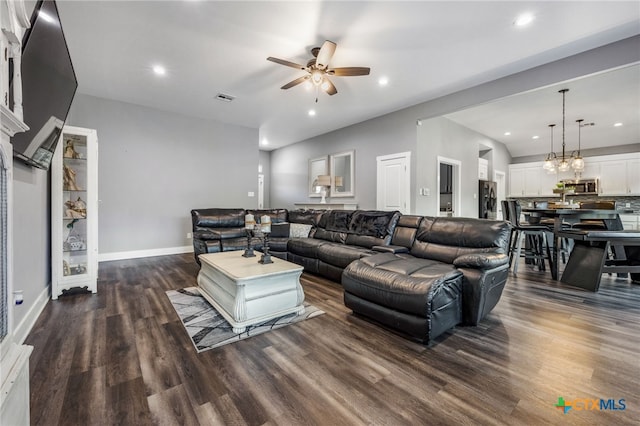 living room featuring dark hardwood / wood-style flooring and ceiling fan