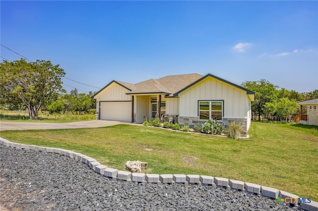 view of front of home with a front lawn and a garage