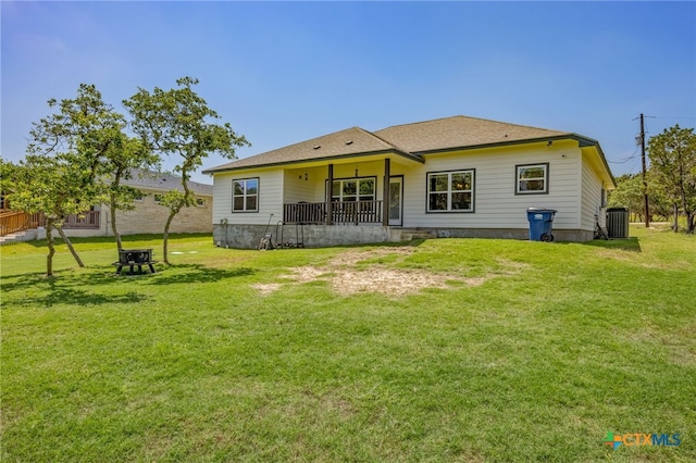 back of property featuring a lawn, central air condition unit, and a porch